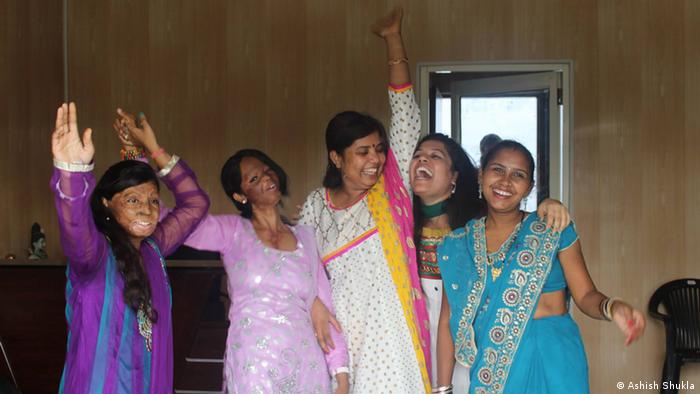 Rupa (left) and Laxmi dance with volunteers (Photo: Ashish Shukla)