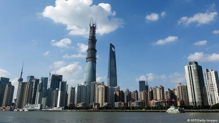 The Shanghai Tower (L) stands next to the Shanghai Global Financial Hub in the Lujiazui area of Pudong district in Shanghai on July 30, 2013. The building will see its main structure's construction completed on August 3rd and will become China's tallest building with a total height of 632 meters. CHINA OUT AFP PHOTO (Photo credit should read STR/AFP/Getty Images)