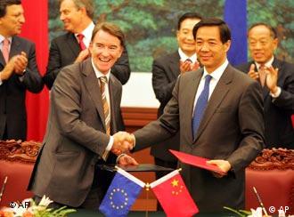 EU Trade Commissioner Peter Mandelson, left, exchanges documents with Chinese Commerce Minister Bo Xilai as leaders clap hands in the background during the EU-China signing ceremony in Beijing Monday, Sept. 5, 2005. Negotiators reached a deal to unblock Chinese textile imports at European ports - a problem that had threatened to sour a China-Europe trade-boosting summit. The deal reached by European Union and Chinese negotiators in Beijing would let about 75 million Chinese-made garments into Europe. Leaders in the background are from left: European Commission President Jose Manuel Barroso, British Prime Minister Tony Blair, Chinese Premier Wen Jiabao and Chinese Foreign Minister Li Zhaoxing. (AP Photo/Claro Cortes IV, Pool)