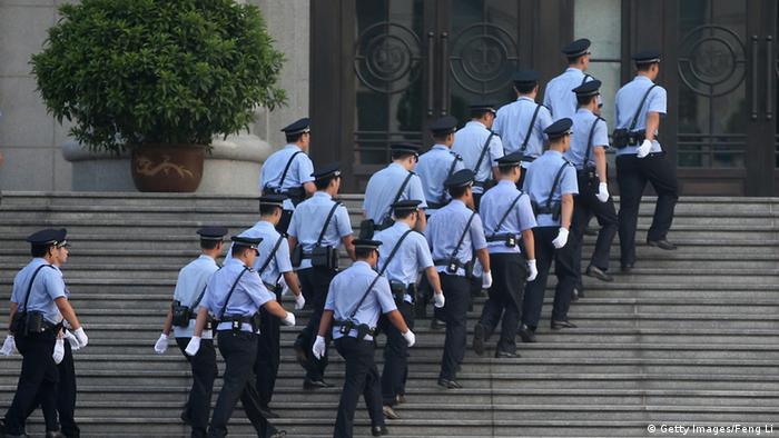 JINAN, CHINA - AUGUST 22: Chinese policemen walk into the Jinan Intermediate People's Court on August 22, 2013 in Jinan, China. Former Chinese politician Bo Xilai is standing trial on charges of bribery, corruption and abuse of power. Bo Xilai made global headlines last year when his wife wife Gu Kailai was charged and convicted of murdering British businessman Neil Heywood. (Photo by Feng Li/Getty Images)