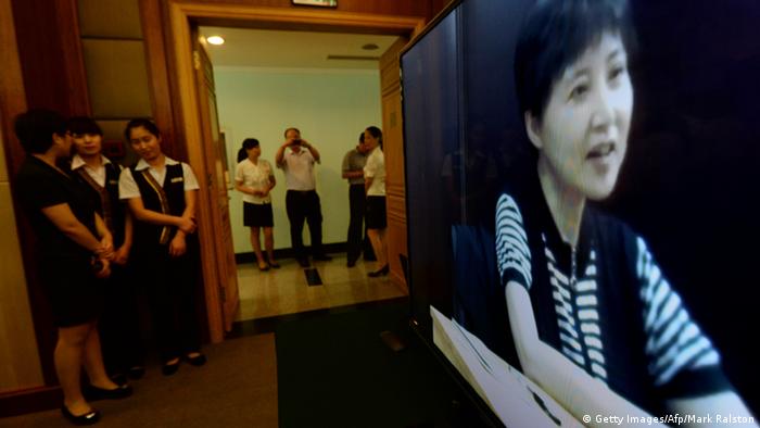 Gu Kailai (R) who is the wife of disgraced politician Bo Xilai gives a recorded testimony during his trial at the Intermediate People's Court in Jinan, Shandong Province on August 23, 2013. Fallen Chinese politician Bo Xilai resumed his defence against bribe-taking charges on August 23, a court said, after he mounted a feisty performance on the trial's opening day. AFP PHOTO/Mark RALSTON (Photo credit should read MARK RALSTON/AFP/Getty Images)