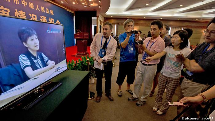 Journalists watch an online pre-recorded testimony by Gu Kailai, wife of former Chinese politician Bo Xilai before a press conference held at a hotel near the Jinan Intermediate People's Court in Jinan, eastern China's Shandong province on Friday, Aug. 23, 2013. Bo is accused of corruption and interference in the investigation of his wife's murder of a British businessman. (AP Photo/Ng Han Guan)