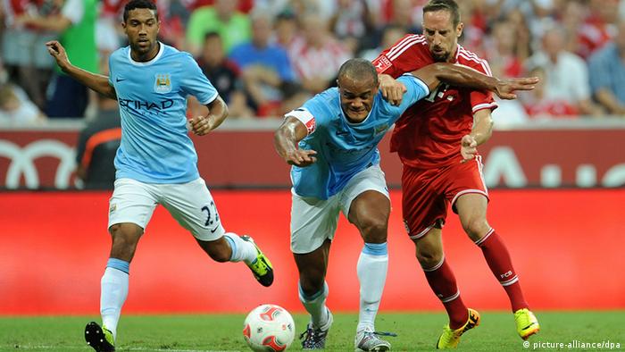 Munich`s Franck Ribery (R) and Vincent Kompany (C) and Gael Clichy of Manchester vie for the ball during the Audi Cup soccer final match FC Bayern Munich vs Manchester City FC at Allianz Arena in Munich, Germany, 01 August 2013. Photo: Andreas Gebert/dpa
