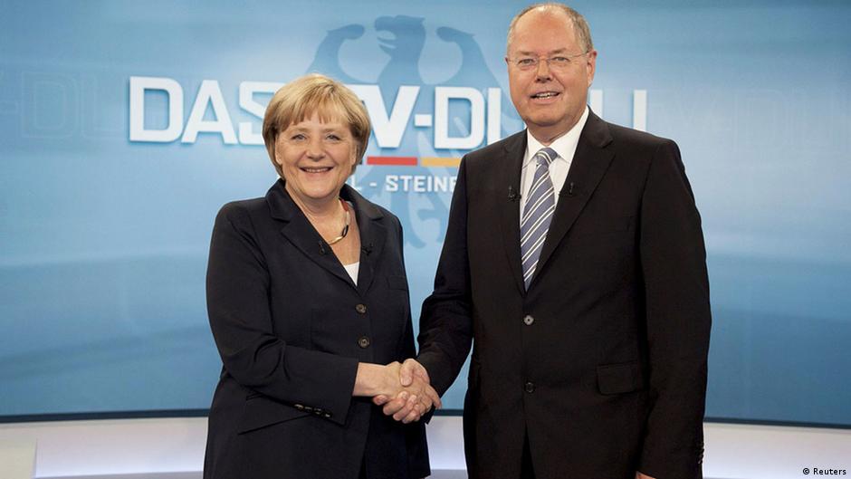 German Chancellor Angela Merkel shakes hands with her challenger, the top candidate in the upcoming German general elections of the Social Democratic Party (SPD), Peer Steinbrueck, during their TV duel in Berlin, September 1, 2013. German voters will take to the polls in a general election on September 22. REUTERS/ARD/Max Kohr/Pool (GERMANY - Tags: POLITICS ELECTIONS) FOR EDITORIAL USE ONLY. NOT FOR SALE FOR MARKETING OR ADVERTISING CAMPAIGNS. MANDATORY CREDIT. ATTENTION EDITORS: PICTURE TO BE USED ONLY IN RELATION TO THE TV DEBATE