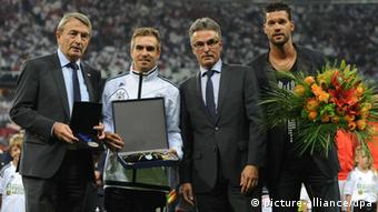 Wolfgang Niersbach, president of the German football association DFB (L), and Helmut Sandrock, secretary general of the German football association DFB (3rd from R), honour Germany's Philipp Lahm (2nd from R) and former team captain Michael Ballack prior to the FIFA World Cup 2014 qualification group C soccer match between Germany and Austria at Allianz Arena in Munich, Germany, 06 September 2013. Photo: Andreas Gebert/dpa +++(c) dpa - Bildfunk+++
