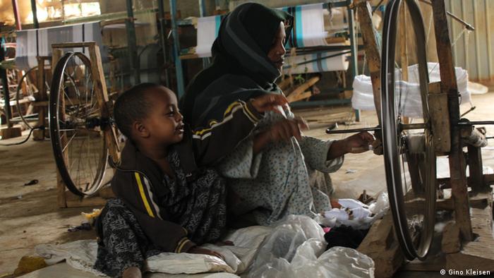 Woman and child in the spinning workshop in Awra Amba