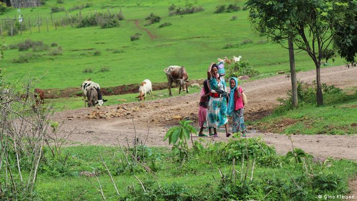 Woman and children return from the fields in Awra Amba
