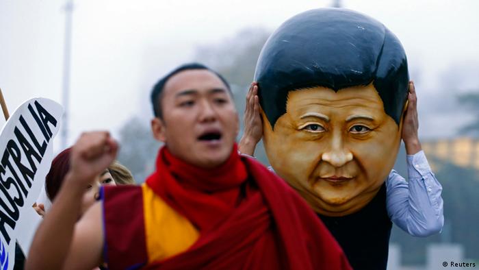 A protester wearing a giant head representing China's President Xi Jinping takes part in a demonstration calling Xi out for rights violations in Tibet in front of the European headquarters of the United Nations in Geneva October 22, 2013. The 17th session of the Human Rights Council's Universal Periodic Review (UPR) Working Group will be held in Geneva from October 21 to November 1 during which 15 states are scheduled to have their human rights records examined under this mechanism. China's review on its human rights situation is scheduled for Tuesday. REUTERS/Denis Balibouse (SWITZERLAND - Tags: CIVIL UNREST POLITICS TPX IMAGES OF THE DAY)