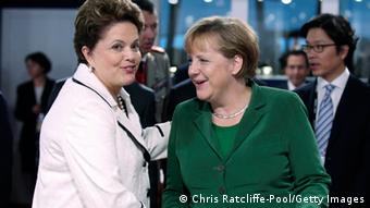 Brazil President Dilma Rousseff (L) shakes hands German Chancellor Angela Merkel 