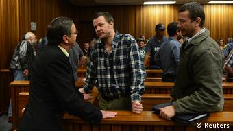 Lets Pretorius chats to his two sons Johan and Wilhelm Pretorius ahead of their sentencing at Pretoria High Court REUTERS/Stringer 