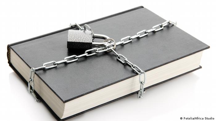 black book with chain, isolated on white (Photo: Africa Studio) 