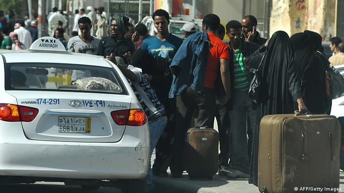Foreign workers wait for a taxi as they leave the Manfuhah neighbourhood of the Saudi capital Riyadh on November 10, 2013, after two people have been killed in clashes between Saudi and other foreign residents the previous day, according to the Saudi police. On November 4, the authorities began rounding up thousands of illegal foreign workers following the expiry of a final amnesty for them to formalise their status. AFP PHOTO/FAYEZ NURELDINE (Photo credit should read FAYEZ NURELDINE/AFP/Getty Images)