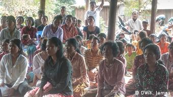 Cambodian villagers gather to listen to a presentation (photo: Kyle James)