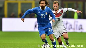 Germany's midfielder Mario Gotze vies for the ball with Italy's midfielder Andrea Pirlo (L) during the FIFA World Cup friendly football match Italy vs Germany on November 15, 2013 at the San Siro stadium in Milan. AFP PHOTO / GIUSEPPE CACACE (Photo credit should read GIUSEPPE CACACE/AFP/Getty Images)