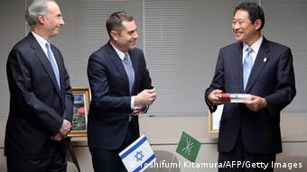 Israeli embassy's Deputy Chief of Mission Peleg Lewi (C) and Jewish community of Japan president Philip Rosenfeld (L) smile with Ryo Tanaka (R) Mayor of Suginami ward during a ceremony to donate 300 copies of Anne Frank's 'Diary of a Young Girl' in Tokyo on February 27, 2014. 