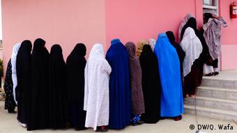 Afghan women are waiting outside of a voter registration center in Ghazni, Afghanistan on 31.03.2014 to get voting card
