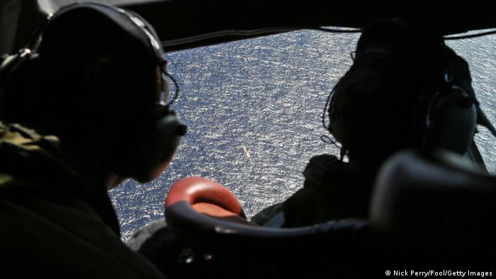 Wing commander Rob Shearer captain of the RNZAF P3 Orion (L) and SGT Sean Donaldson look out the cockpit windows during search operations for missing Malaysia Airlines Flight MH370 in Southern Indian Ocean on April0 4, 2014, near Australia.