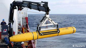 Crew aboard the Australian Defence Vessel Ocean Shield move the U.S. Navy’s Bluefin-21 autonomous underwater vehicle into position for deployment in the southern Indian Ocean to look for the missing Malaysia Airlines flight MH370, April 14, 2014.