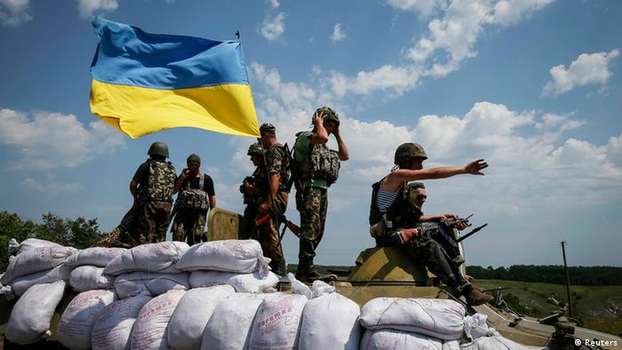 Soldiers with a Ukraine flag in the country's east