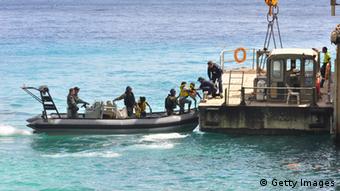 Suspected asylum seekers arrive at to Flying Fish Cove, Christmas Island, after being intercepted and escorted in by the Australian Navy, on August 3, 2013 near Christmas Island, Indian Ocean Territories, Australia
(Photo:Scott Fisher/Getty Images)
