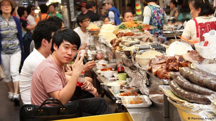 People eating Korean street food