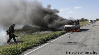 A car burning by the side of the road. (Photo: ITAR-TASS/ Valery Matytsin)