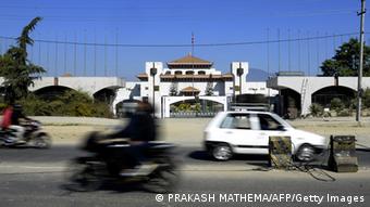 A motorcycle drives past the Nepalese parliament in Kathmandu