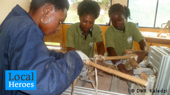 Selby and two of her employees work on a bamboo bike in Kumasi
