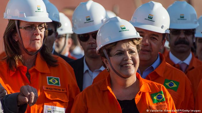Rousseff und Gracas in Ölarbeiteruniform und Helm (Foto: AFP PHOTO/VANDERLEI ALMEIDA)