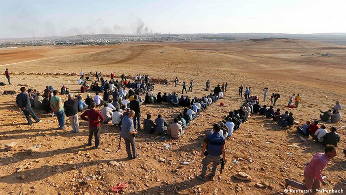 Turkish Kurds gather on the hill near the Mursitpinar border crossing on the Turkish-Syrian border near the southeastern town of Suruc in Sanliurfa province to support Kurdish fighters in Koban October 15, 2014