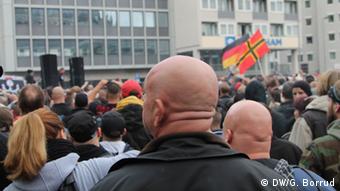 Two men with shaved heads are pictured at the rally in Cologne