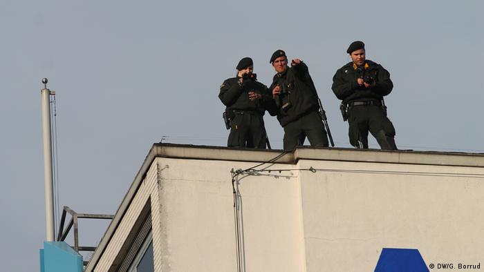 Members of German intelligence look on from above the rally
