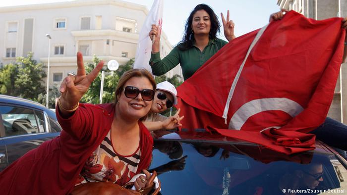 Supporters of the Nida Tounes (Call of Tunisia) secular party movement wave flags and shout slogans outside Nidaa Tounes headquarters in Tunis October 28, 2014.