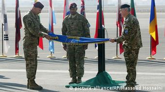 International Security Assistance Force Joint Command (IJC), Lieutenant General Joseph Anderson, left, folds the flag of IJC during a flag-lowering ceremony in Kabul, Afghanistan, Monday, Dec. 8, 2014
(AP Photo/Massoud Hossaini)