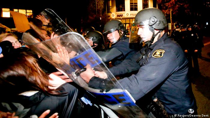 Police officers with the Berkeley Police Department clash with protesters during a march against the New York City grand jury decision to not indict in the death of Eric Garner 