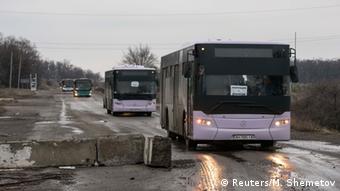 Empty buses, intended for people fleeing from the Debaltseve drive towards the village.