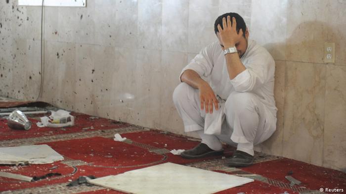 A family member of a slain victim mourns after arriving at the Imam Ali mosque, the site of a suicide bomb attack, in the village of al-Qadeeh in the eastern province of Gatif, Saudi Arabia, May 22, 2015.