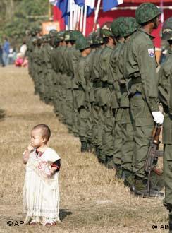A young Karen child seems lost in a Karen Army formation Tuesday, Jan. 31, 2006, during Revolution Day ceremonies at their camp New Manerplaw, Myanmar.  The day marks the 57th anniversary of the Karen's break from the government in Yangon.  The 57 year armed resistance is one the longest running rebel insurgency in the world.  The Karen are an ethnic minority in Myanmar.  (AP Photo/David Longstreath)