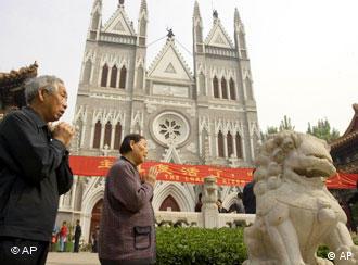 Chinese faithfuls pray outside the Xishiku Catholic Church in Beijing, China, Sunday, May 7, 2006. China on Sunday rejected Vatican criticism of its ordination of two Roman Catholic bishops without papal approval as the official Chinese church prepared to name yet another bishop. (AP Photo/Ng Han Guan)
