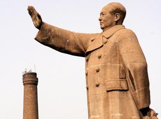The statue of Mao Zedong, the founder of the People's Republic of China, stands next to a factory chimney which has been stopped operating due to local government regulation March 22, 2007 in Taiyuan, China. China promised Monday, June 4, 2007 to reduce greenhouse gases, unveiling a new national climate change program, but rejected mandatory caps as unfair to countries still trying to catch up with the developed West. (AP Photo/Eugene Hoshiko)