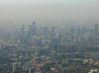 A layer of smog hangs over central Beijing, as seen from a plane Wednesday, Oct. 4, 2006. Authorities have promised to reduce choking pollution as Beijing prepares to host the 2008 Olympic Games. Polluting factories are to be closed and moved out of the city, and Olympics organizers have discussed limiting the use of cars in order to reduce smog. (AP Photo/Greg Baker)