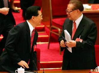 Chinese Communist Party leader Hu Jintao, left, chats with former President and Communist Party leader Jiang Zemin after Hu's speech at the opening of the 17th Communist Party Congress in Beijing's Great Hall of the People Monday, Oct. 15, 2007. Hu opened the congress, held once every five years, by promising modest political reforms while insisting one-party rule will not be weakened. (AP Photo/Greg Baker)