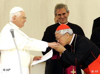Chinese Cardinal Joseph Zen Ze-Kiun, right, Bishop of Hong Kong, kisses the hand of Pope Benedict XVI after the traditional Angelus prayer in Lorenzago di Cadore, near Belluno, Italy, Sunday, July 22, 2007. Benedict XVI called Sunday for an end to all wars, saying they were useless slaughters'' that bring hell to paradise on Earth. Benedict plans to stay in Lorenzago, near Italy's border with Austria, until July 27, when he moves to the papal summer retreat at Castel Gandolfo, in the hills south Rome. (AP Photo/Antonio Calanni)