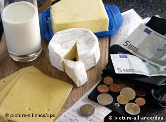 Dairy products next to some banknotes and coins