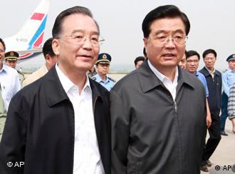 In this photo distributed by the official Chinese news agency Xinhua, Chinese Premier Wen Jiabao, left,  greets President Hu Jintao, right, upon Hu's arrival in Mianyang, a city in quake-hit southwestern Sichuan province, on Friday May 16, 2008.   (AP Photo/Xinhua, Ju Peng) 