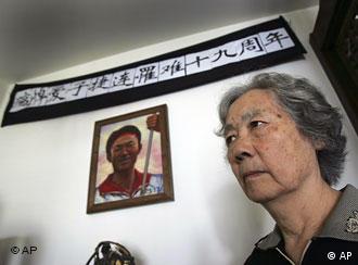 Ding Zilin, co-founder of the Tiananmen Mothers, a group representing families of those who died in the 1989 crackdown on pro-democracy demonstrations, stands in front of a shrine to her son, Jiang Jielian, at her apartment in Beijing Wednesday June 4, 2008. Wednesday is the 19th anniversary of the military assault in which hundreds, possibly thousands, were killed as Chinese troops shot their way through the city to end weeks of protests in Tiananmen Square. Ding's 17-year-old son was killed in the assault. (AP Photo/Greg Baker)