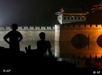 People sit along the Great Wall of China at Juyong Guan Pass on the opening night of  the Beijing 2008 Olympics  Friday, Aug. 8, 2008. 2008. (AP Photo/Lynne Sladky)