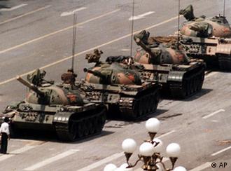 A Chinese protestor blocks a line of tanks heading east on Beijing's Cangan Blvd. June 5, 1989 in front of the Beijing Hotel. The man, calling for an end to the violence and bloodshed against pro-democracy demonstrators, was pulled away by bystanders, and the tanks continued on their way.  (AP Photo/Jeff Widener)