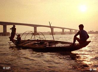 Cambodians paddle fishing boats on Mekong River, Kampong Cham, Cambodia. 