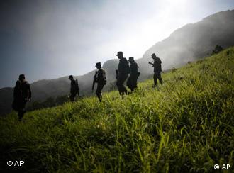 Mexican army soldiers pass near a clandestine methamphetamine laboratory in Tamazula, Mexico, during an operation Monday, Aug 10, 2009. According to federal law enforcement authorities, the lab had the capacity to produce about one ton of methamphetamine, or crystal meth, each week. (AP Photo/Miguel Tovar)